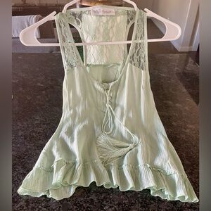 Flowy and soft mint green tank with ruffles and lace and open back.